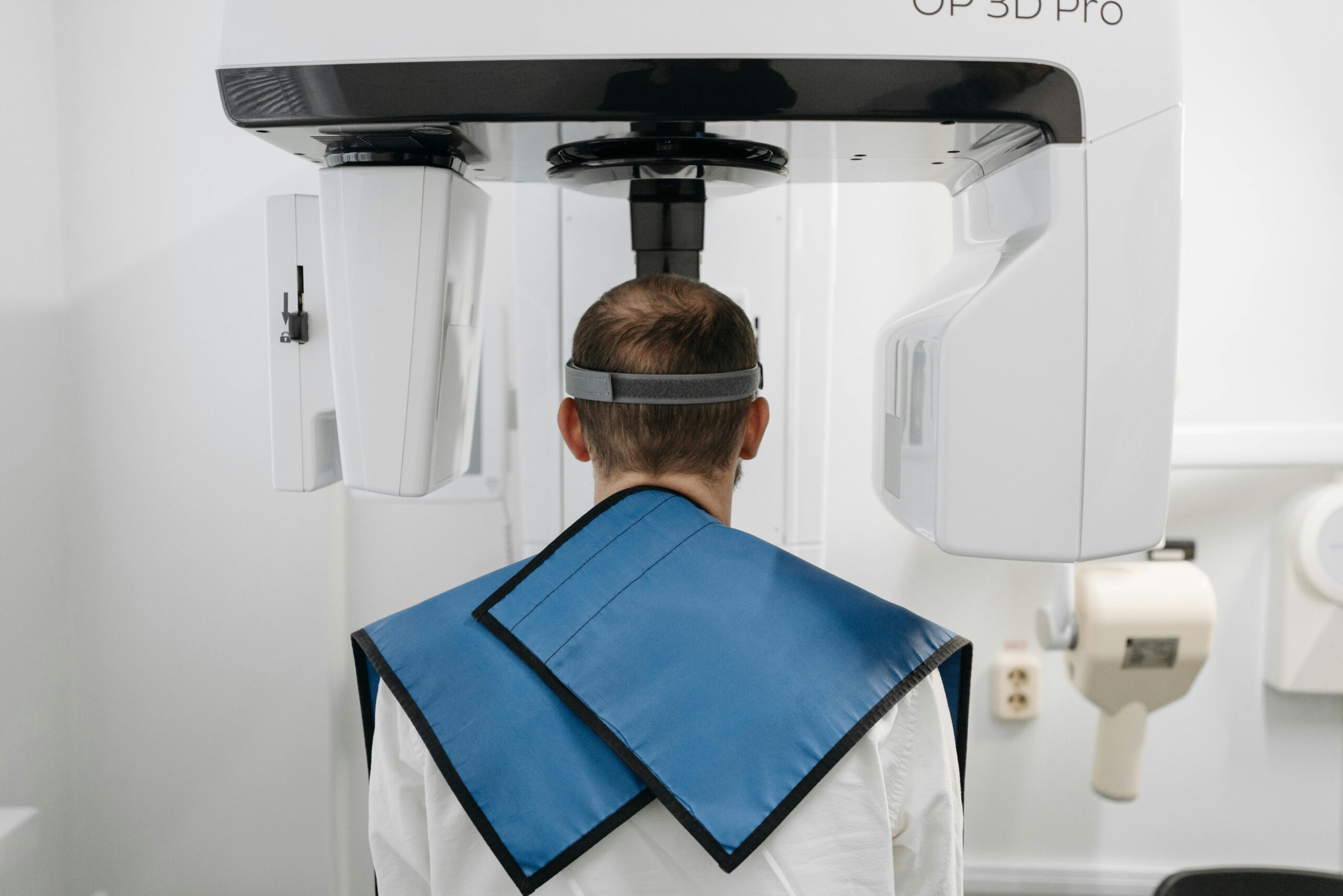 Man undergoing a panoramic radiograph with modern dental technology in a clinic.